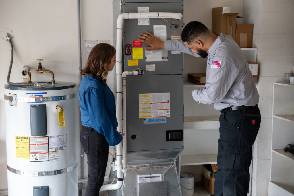HVAC tech working on HVAC system in home.
